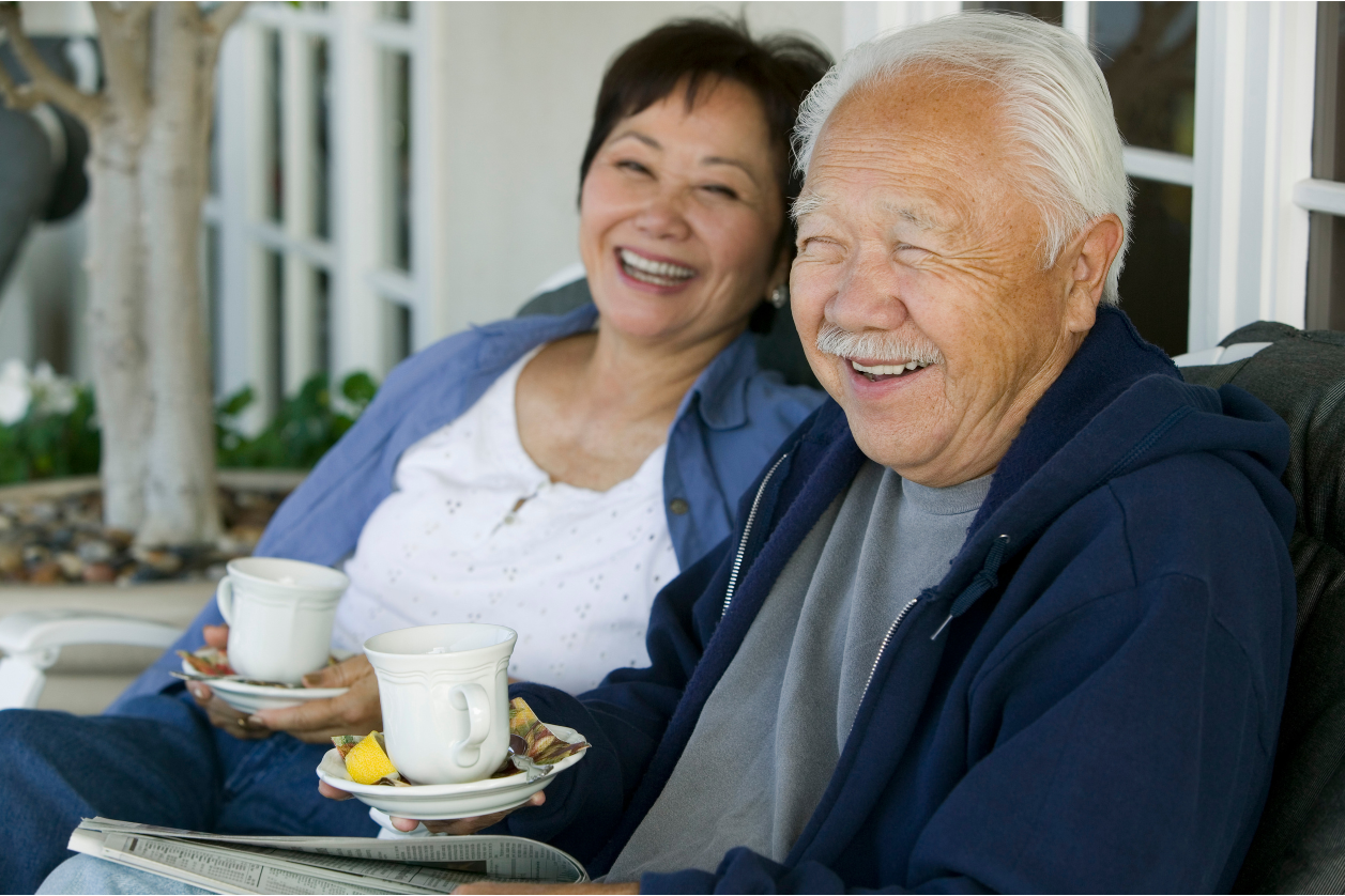 Older adults with dementia going through daily routine of drinking coffee outside.