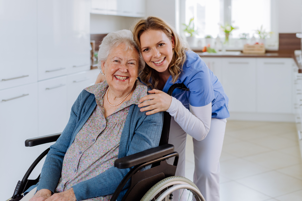 Caregiver with older adult with dementia sitting in a wheelchair.