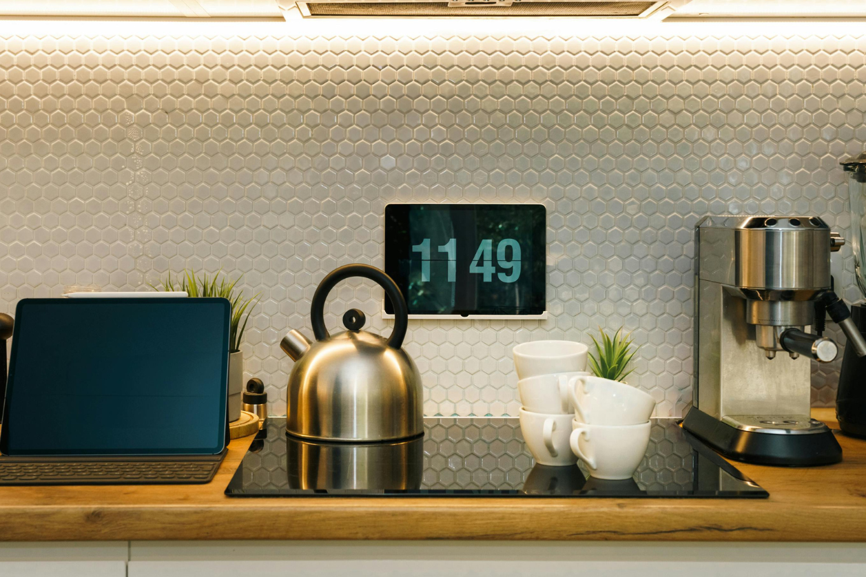 Digital message board in a home kitchen displaying the time.