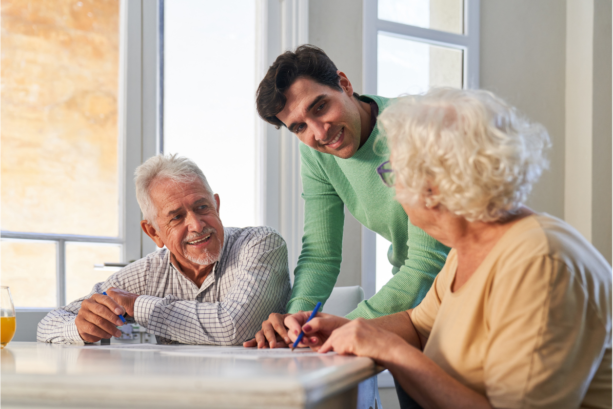 Dementia patients looking at a memory board together in a living room.