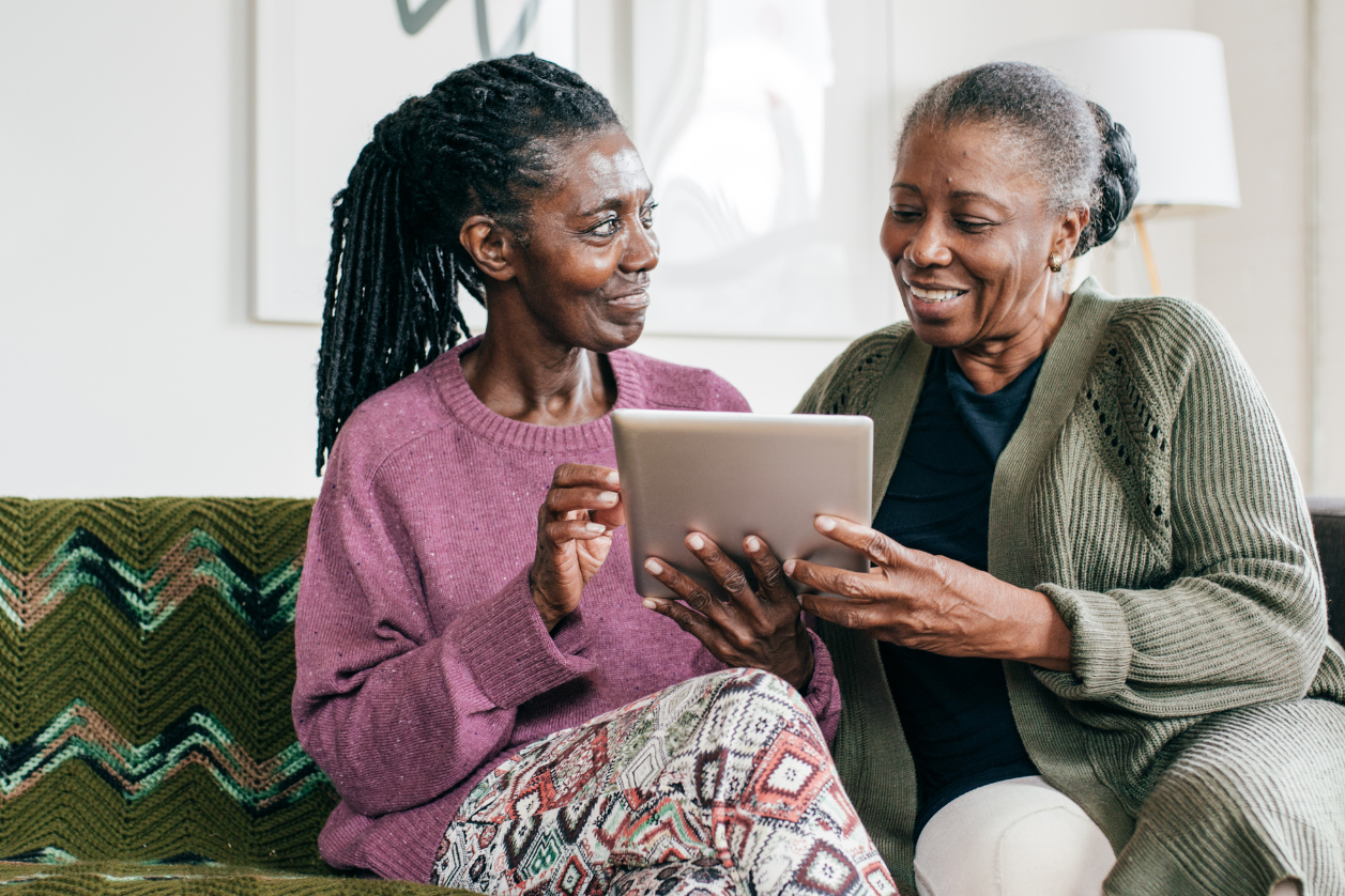 Woman with dementia and her daughter looking at their message board