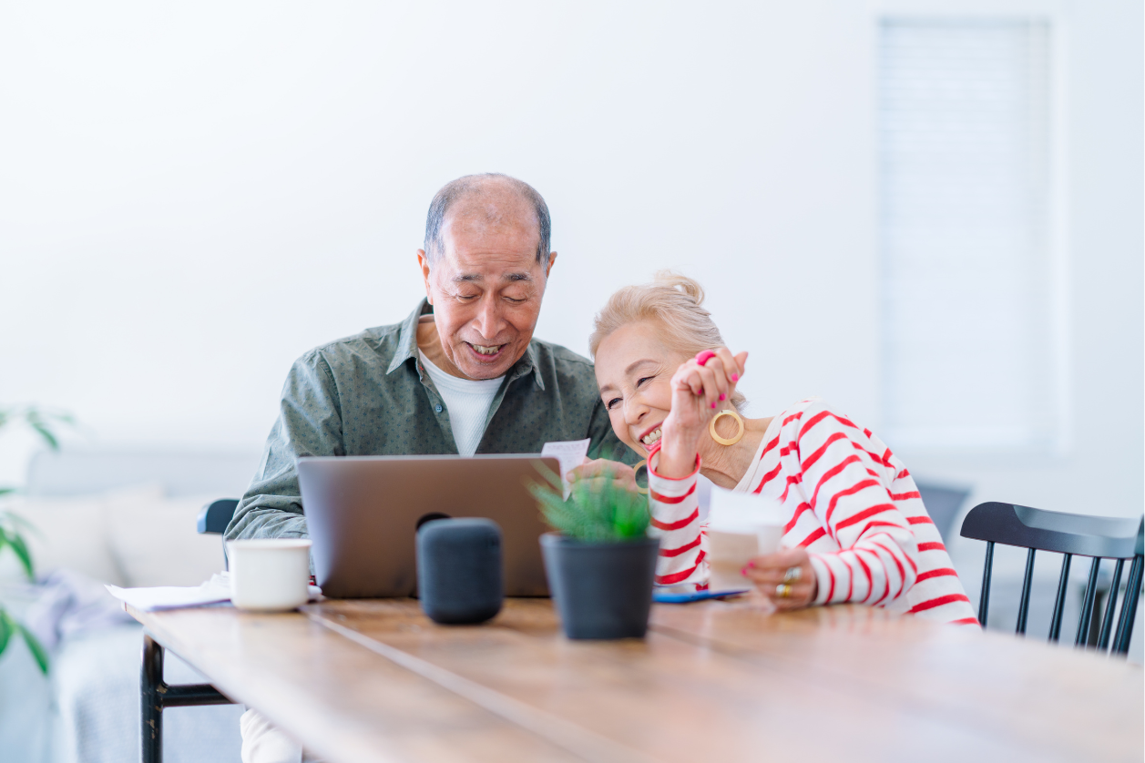 Adults with dementia looking at a dementia message board in the kitchen.