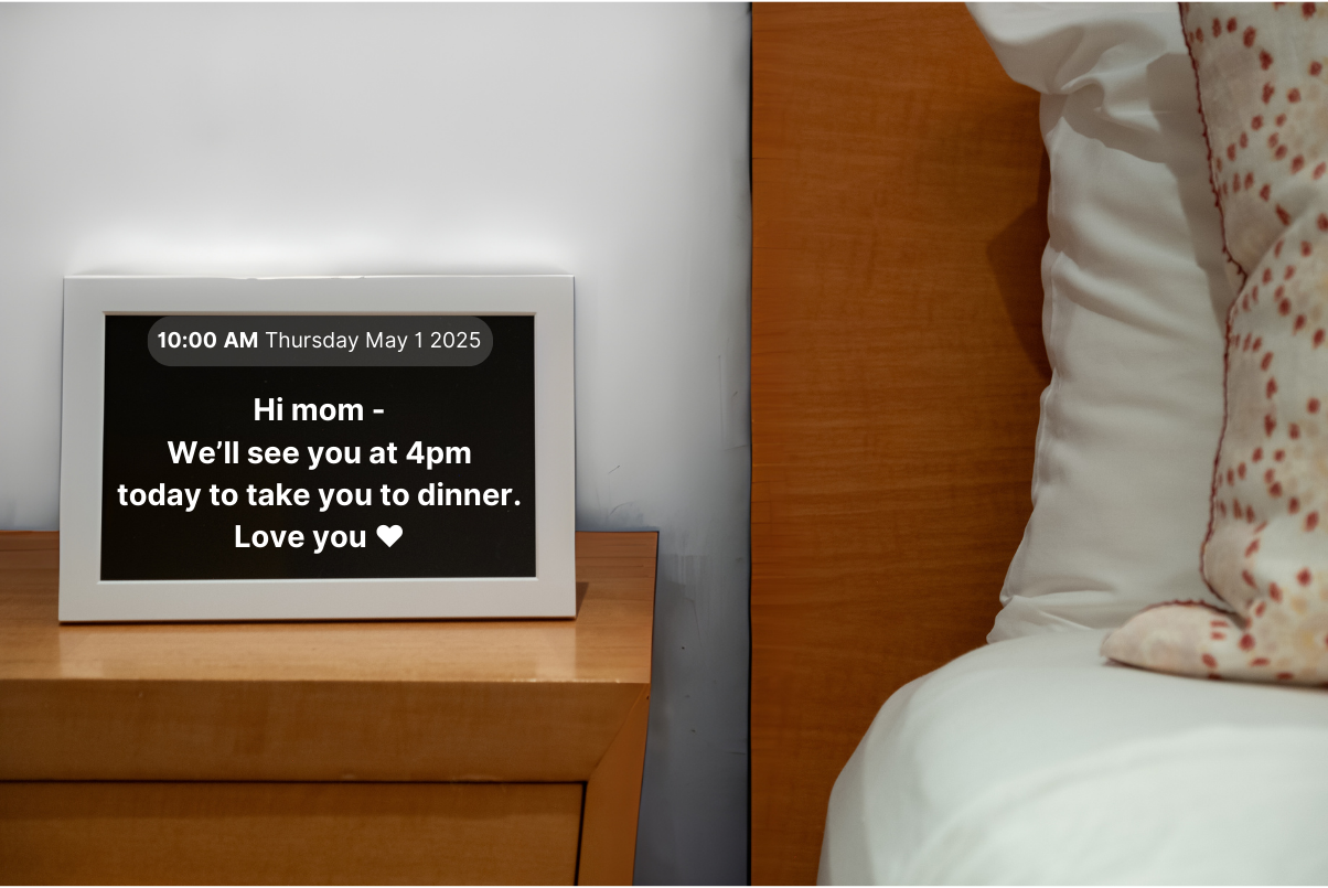 Memoryboard by bedside table with message reminder about dinner plans.
