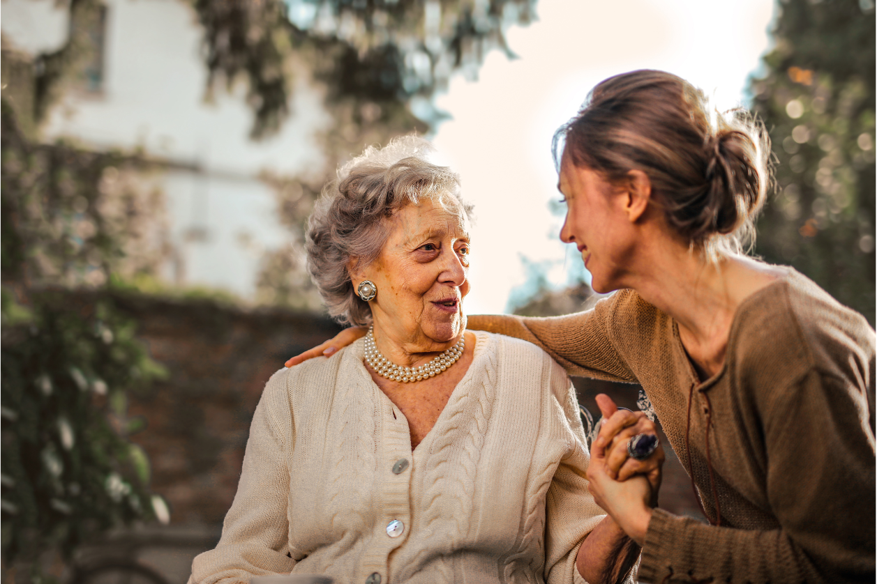 Adult daughter with mom with dementia outside doing their daily routine together.