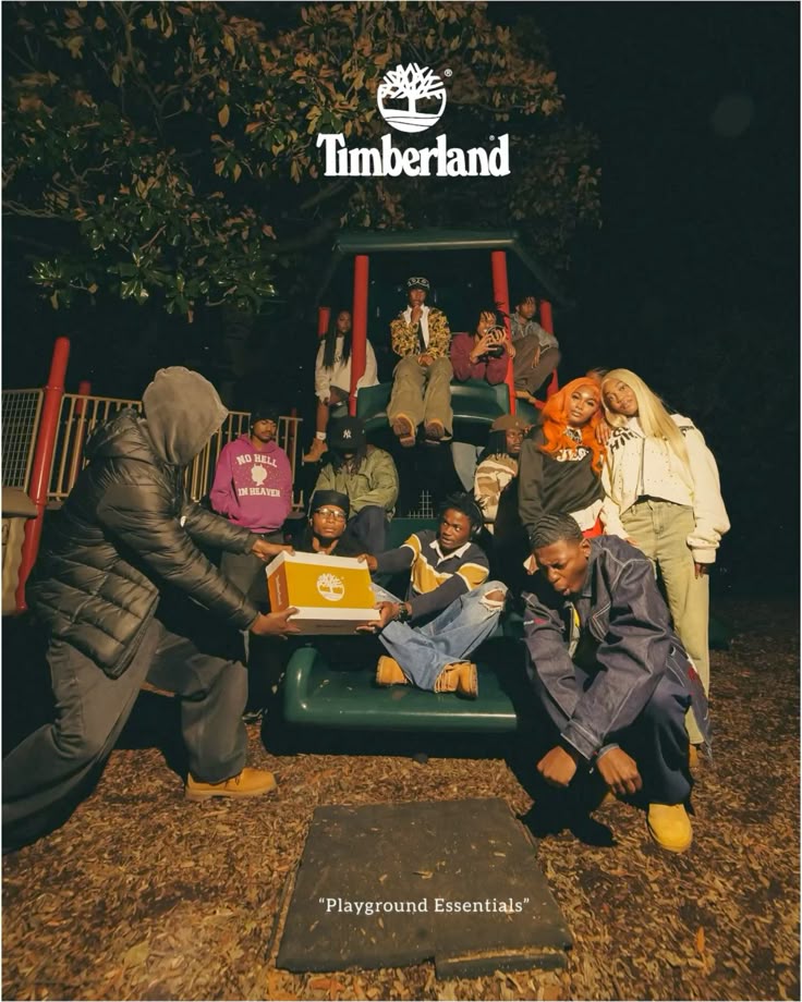Timberland campaign image: a group gathered on a playground slide at night, passing a Timberland shoe box between them, several wearing wheat Timberland boots