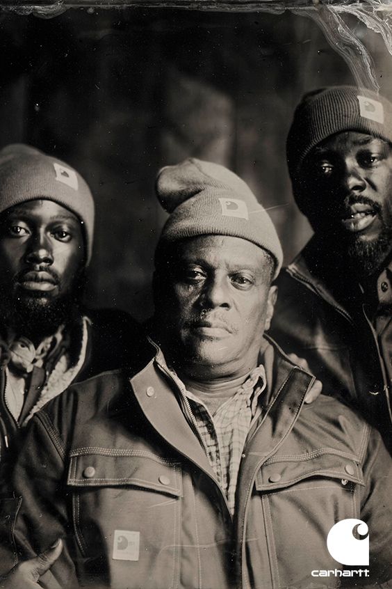 Carhartt campaign portrait: three men in Carhartt work jackets and beanies, shot in a sepia wet-plate style