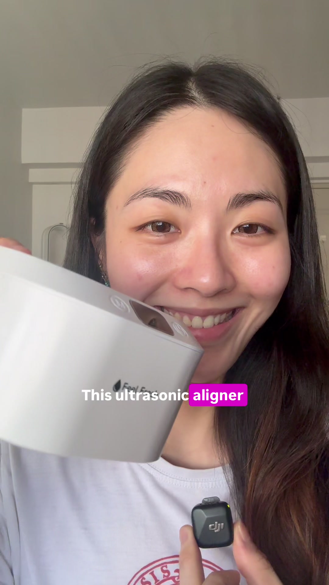 Customer smiling while holding her ultrasonic cleaner with her retainer inside