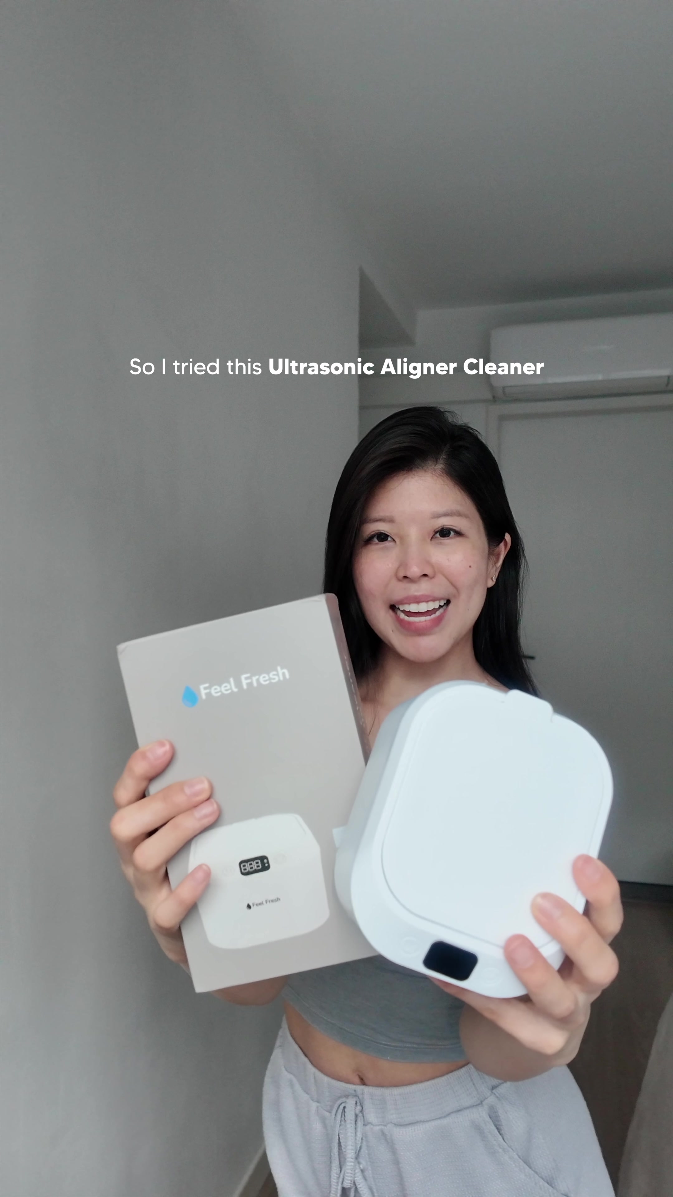 Hands placing clear aligner trays into a UV sanitising case