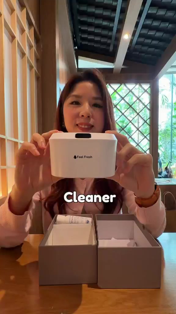Customer using a cordless water flosser at his bathroom mirror
