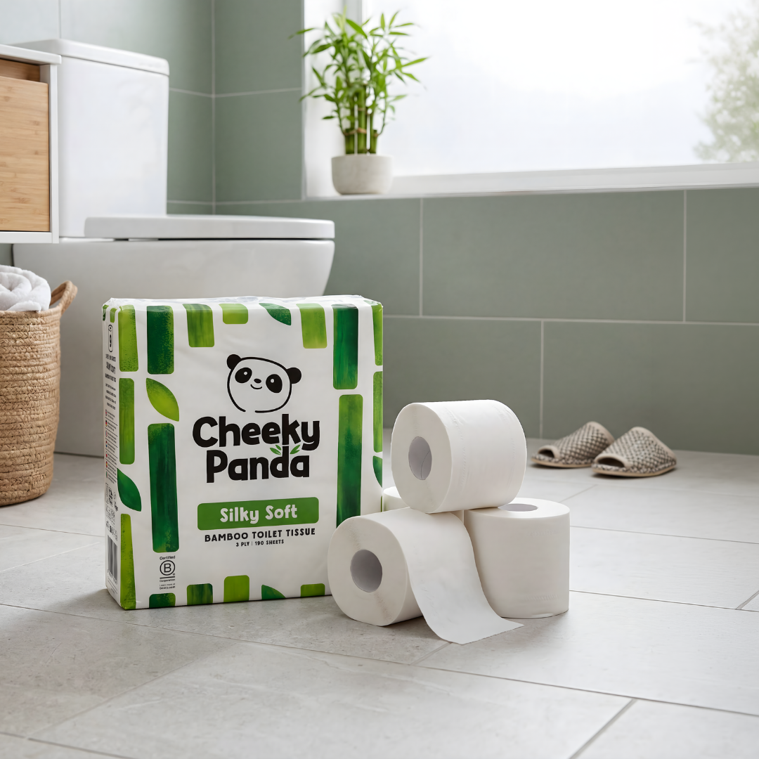 A roll of soft white bamboo toilet tissue on a holder in a bright modern bathroom