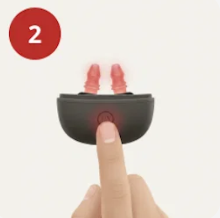 Step 2: finger pressing the power button on the Fitora device with glowing red tips