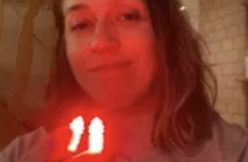 Customer using the Fitora red light device at home, glowing red at her nose