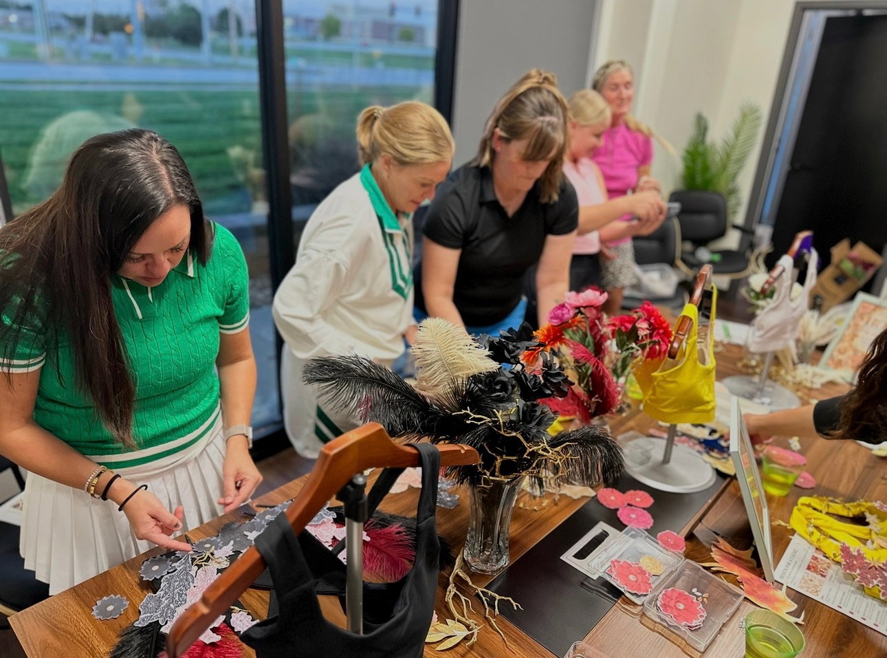 The women of Girly Pop Golf collaborating around the table at the Golden Thread workshop