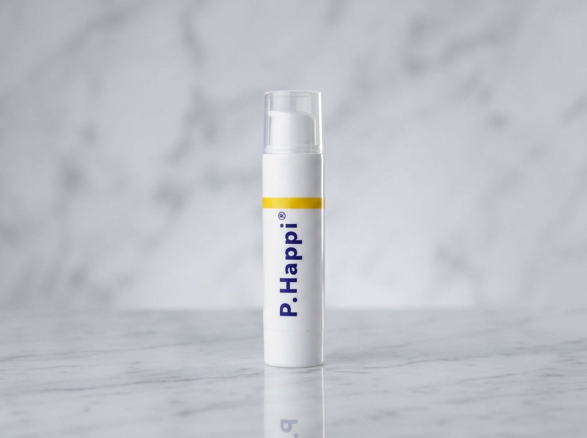 White cylindrical skincare bottle with P.Happi logo and yellow stripe on marble surface