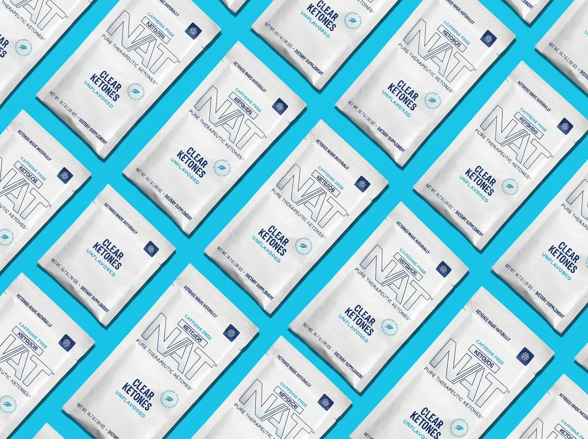 Multiple white packs labeled Clear Ketones by Clear NAT arranged diagonally on a blue background