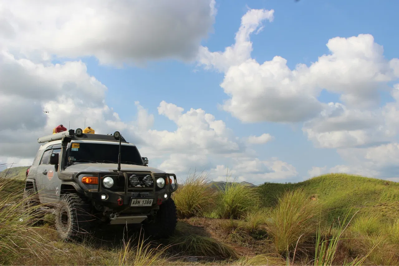 Overlanding rig going over hill