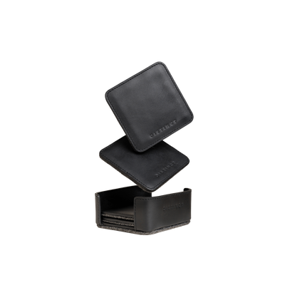 Stacked black leather coasters