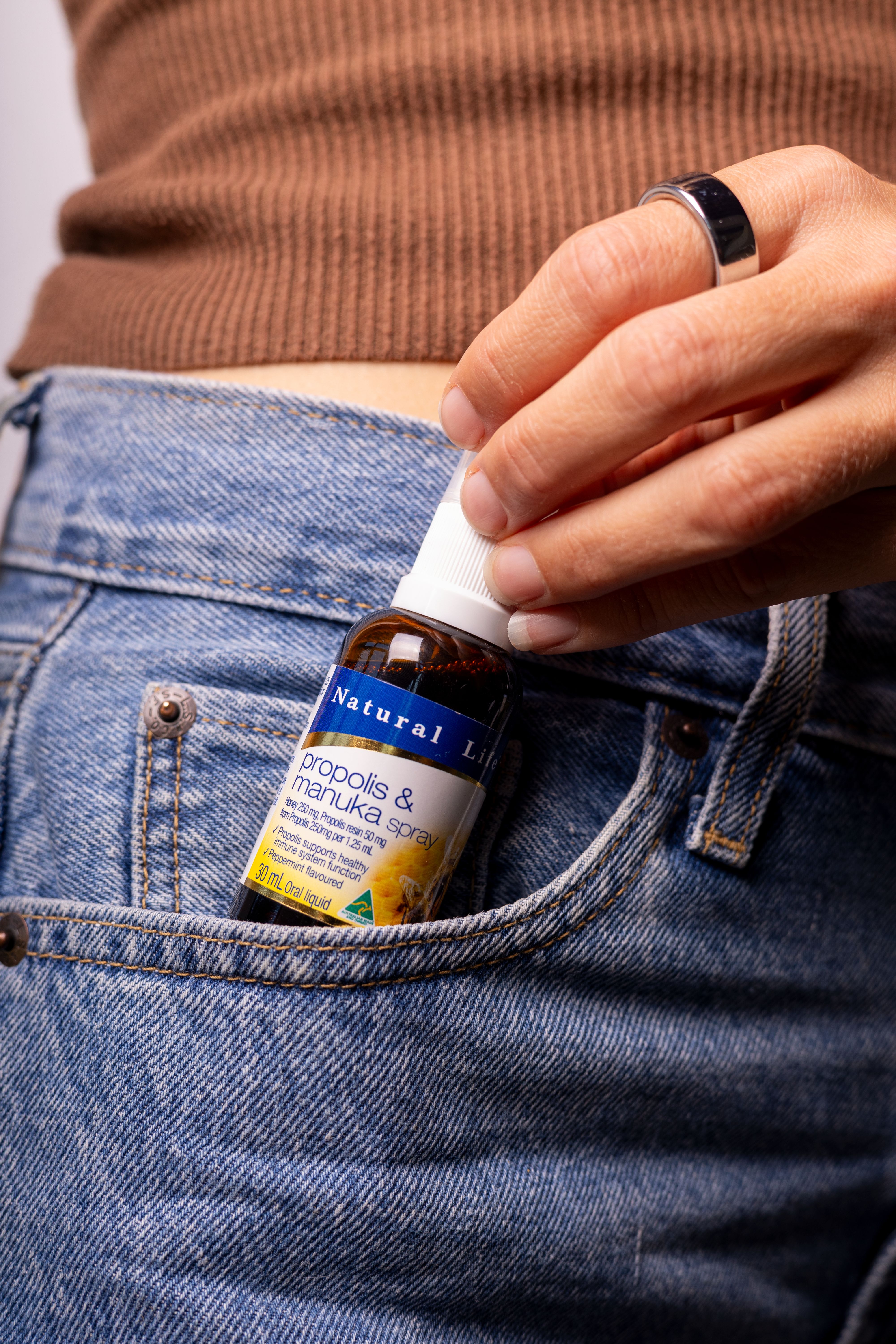 Propolis & Manuka Honey Spray slipped into a jeans pocket