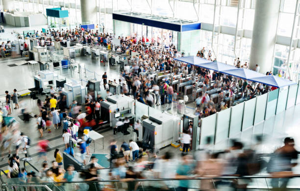 Crowded airport security hall full of travellers