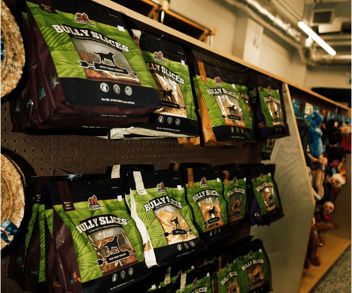 Packages of Bully Slices dog treats hanging on a store shelf