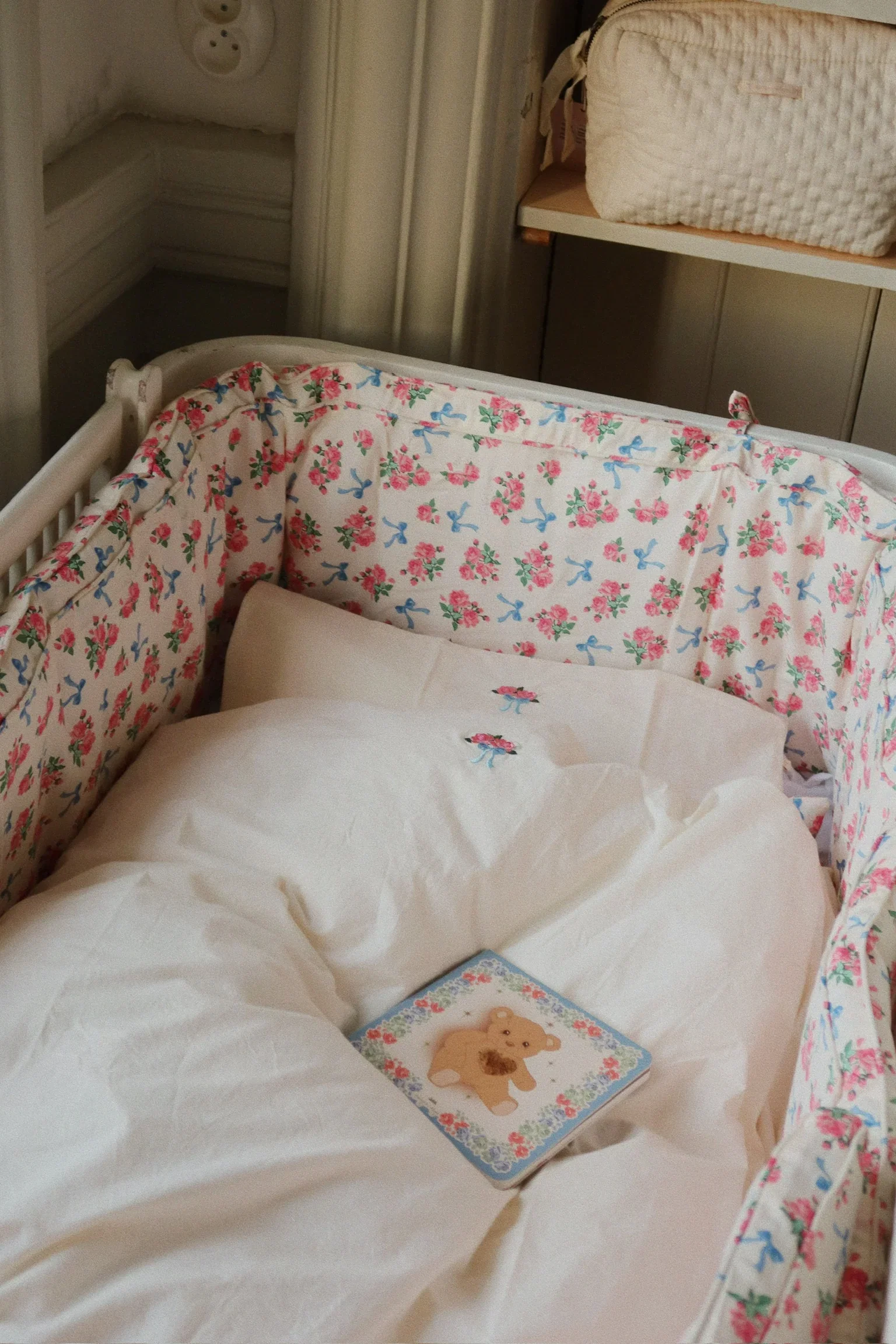 A boutique hotel family suite with a canopy bed, play tent, paper lanterns and baskets of wooden toys in soft daylight