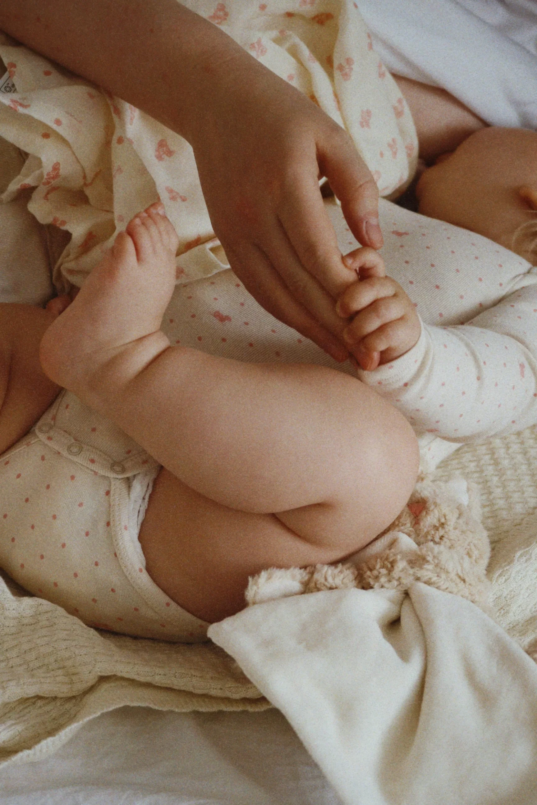 Newborn baby wrapped in a soft cream knitted blanket