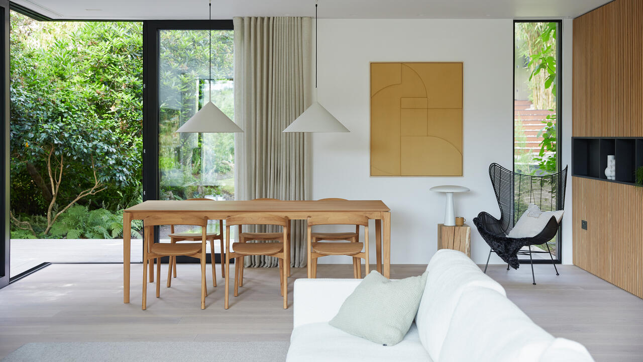 Library interior with oak shelving, reading tables and a hard wax oiled oak floor