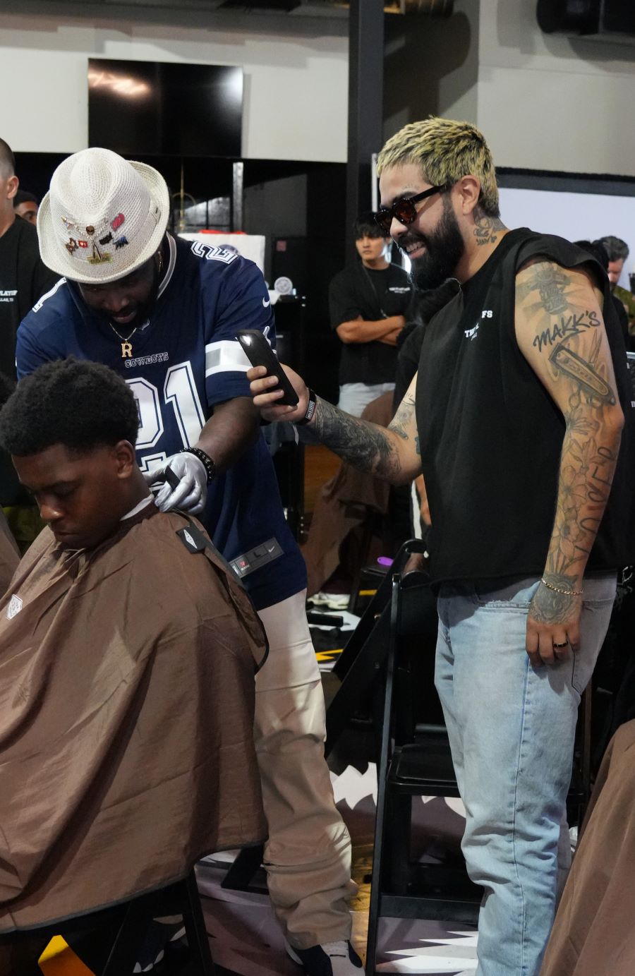 Live barber demo on stage with the audience filming