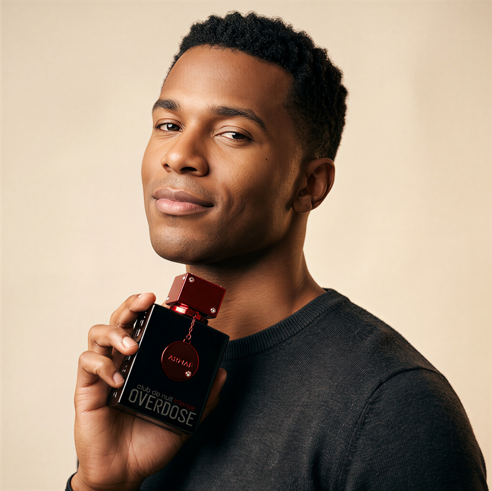 Smiling woman holding an open jar of tinted balm foundation beside her face