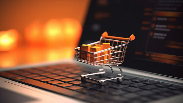Laptop with a shopping basket representing e-commerce and retail