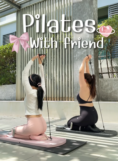 Two people doing Pilates outdoors