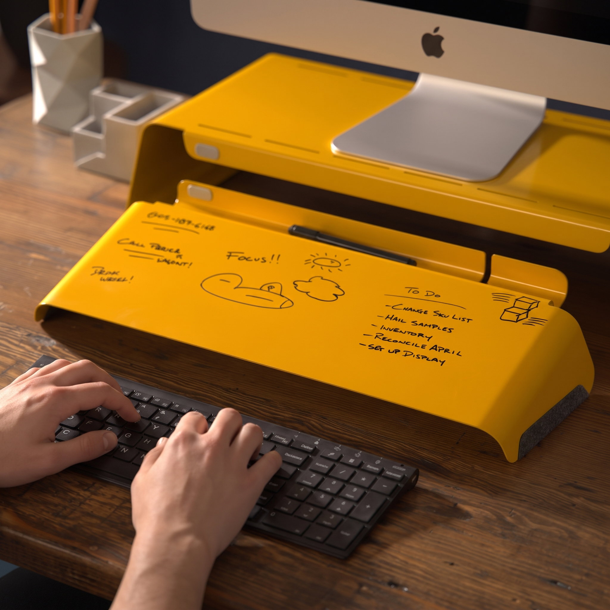 Honeycomb Slope desk whiteboard covered in handwritten notes and a to-do list, sitting in front of a monitor stand above a keyboard