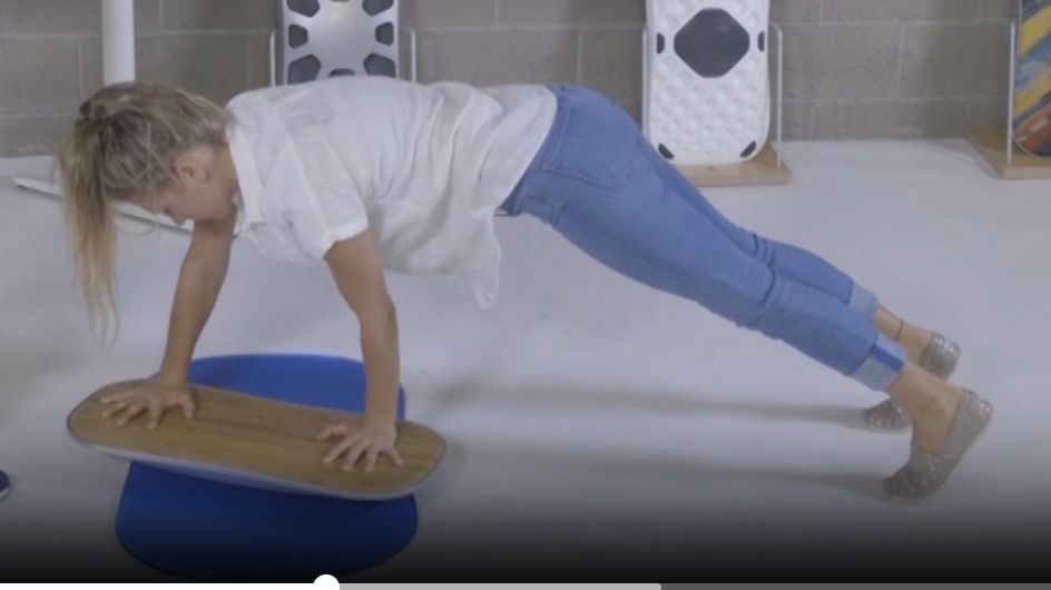Plank exercise with hands on a FluidStance balance board, from Pop-Up Workout Episode 4