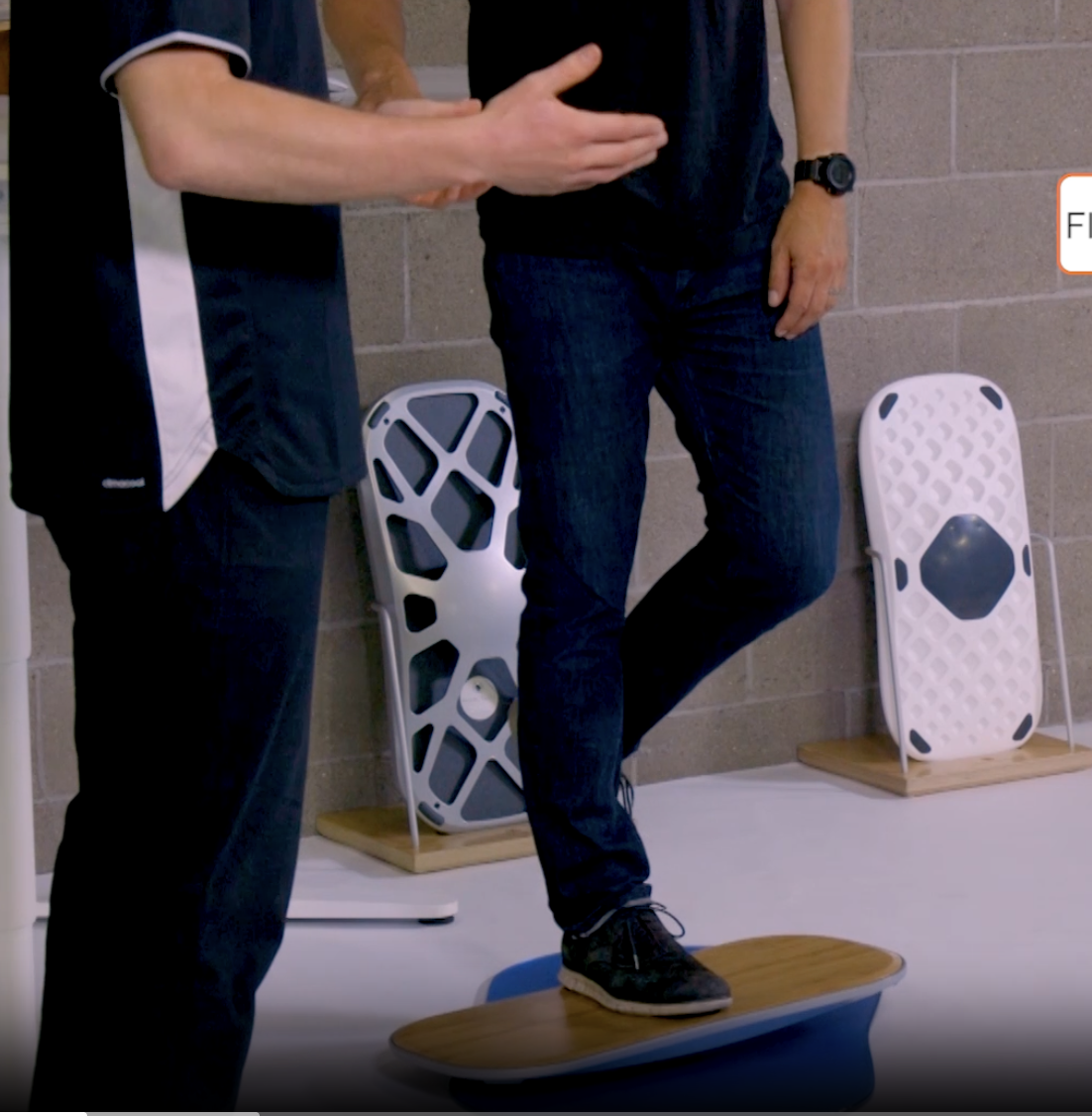 Single leg balance standing desk exercise on a FluidStance balance board, coached by The Lab