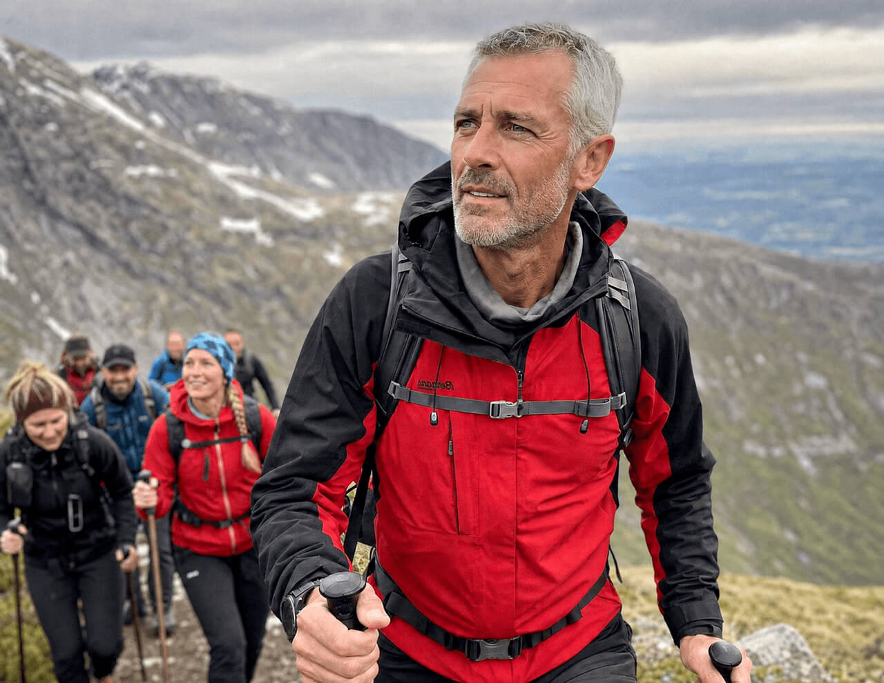 Man in his fifties hiking a mountain trail with friends