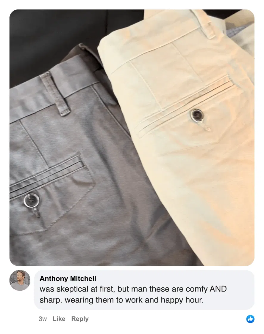 Two pairs of neatly folded pants, one gray and one beige, with buttoned back pockets.