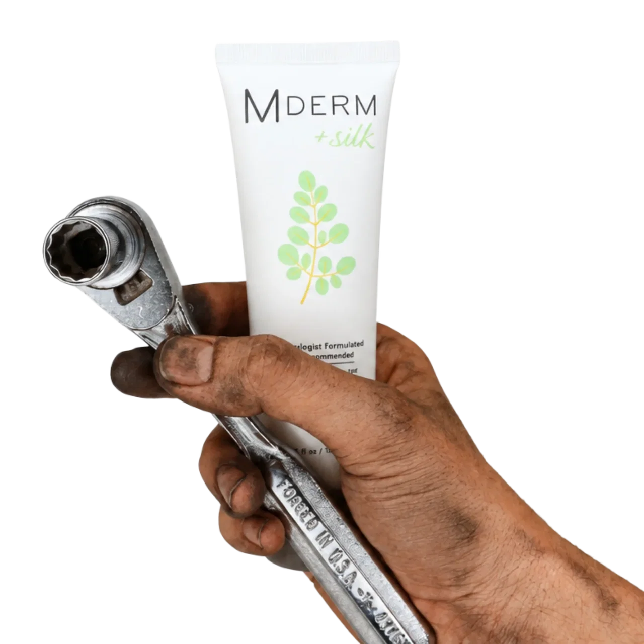 Mechanic's grease-stained hand gripping a socket wrench and a 4 oz tube of MDERM +silk moisturizer.