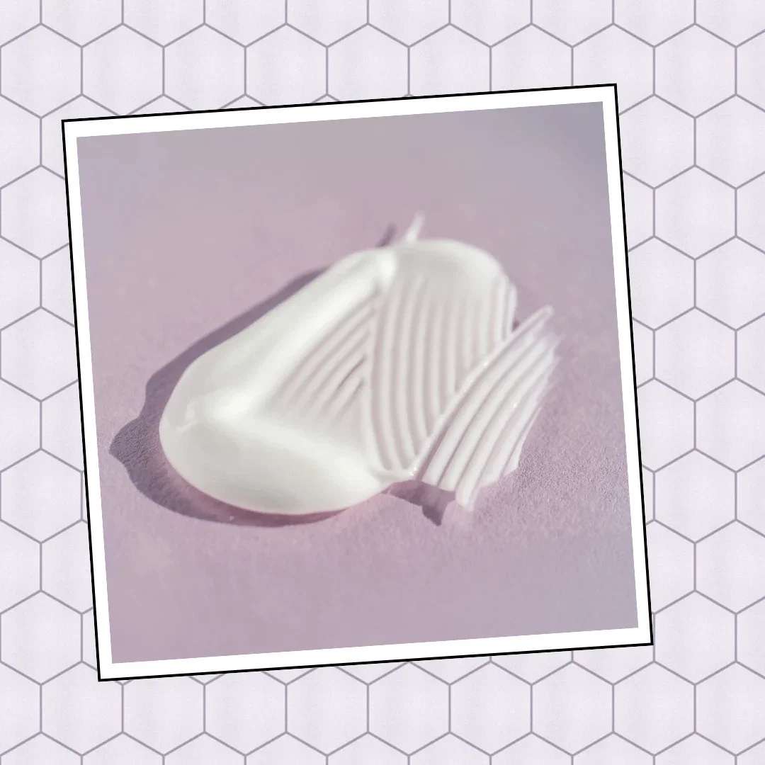 A swatch of white cream with ridged texture on a lavender background representing ceramid
