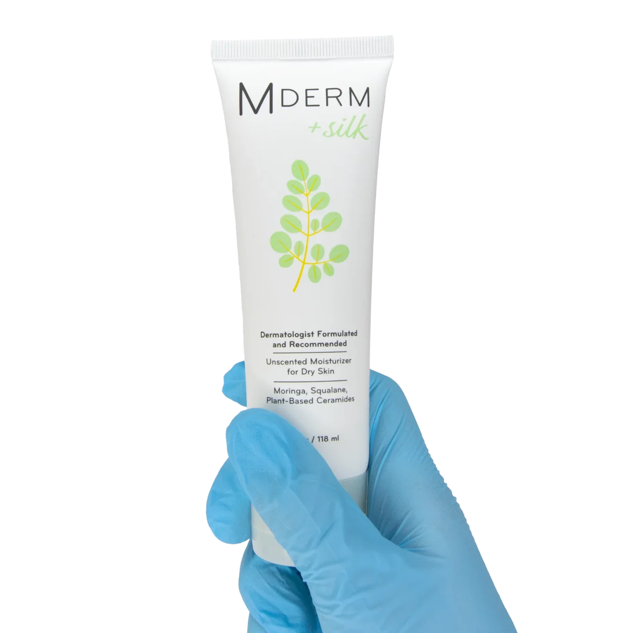 Blue nitrile-gloved hand holding a 4 oz tube of MDERM +silk unscented moisturizer for dry skin.