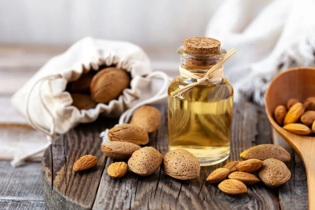 Fresh almonds representing soothing sweet almond oil ingredient in Crème unscented body oil