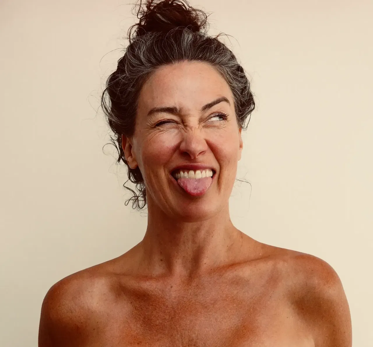Joyful portrait of Samantha celebrating body positivity and sensual wellness journey