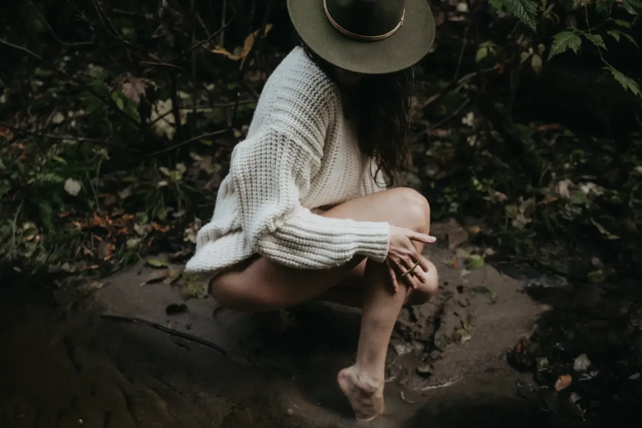 Natural outdoor portrait of woman in midlife embracing wellness and body confidence