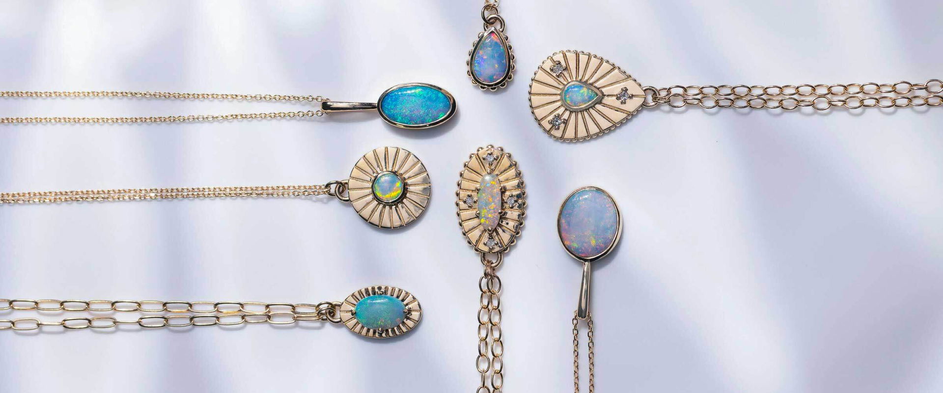 Sunburst-inspired opal pendants and bracelets in 14k gold from Sara Gallo’s signature collection.	