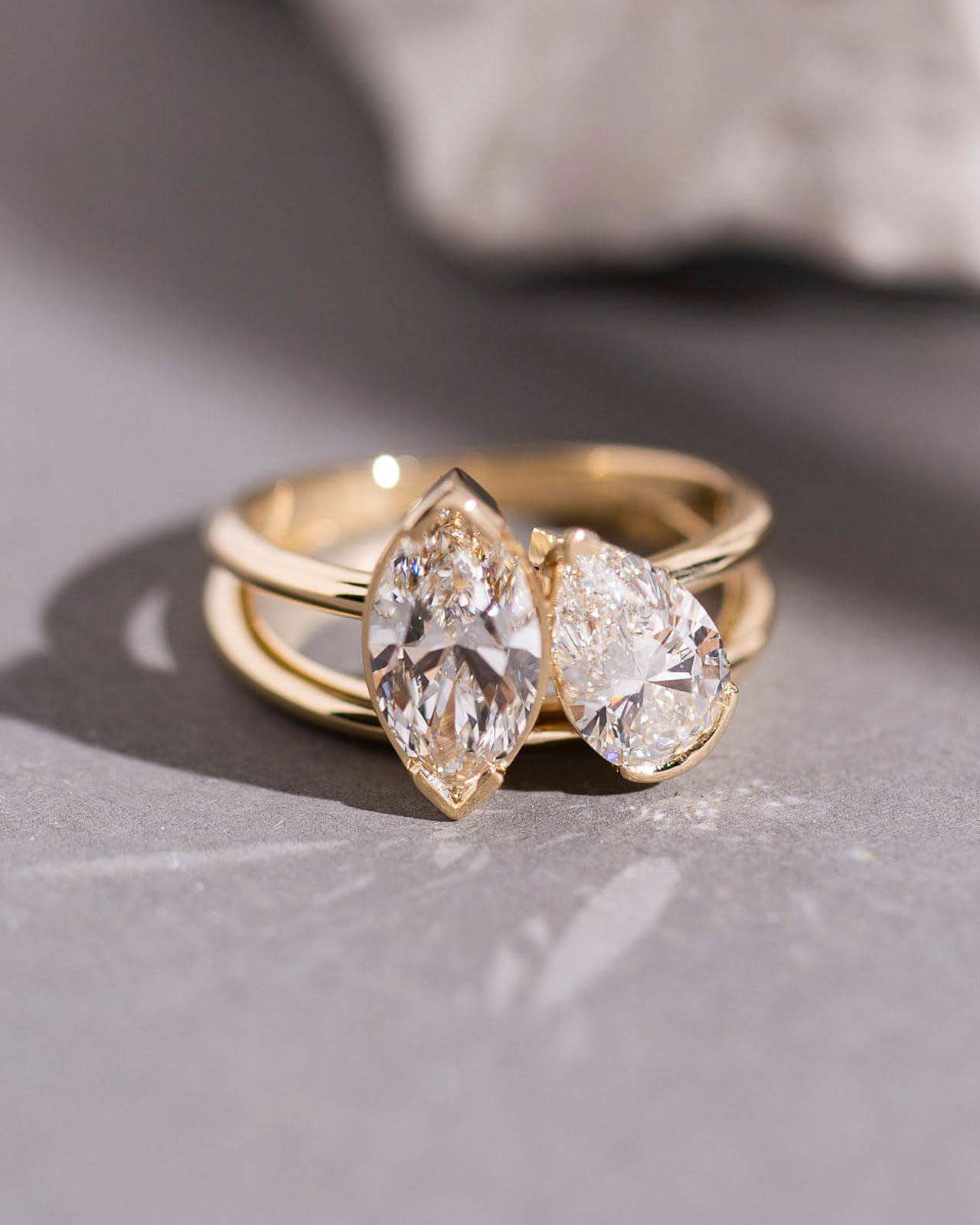 Close-up of marquise & pear diamond bypass ring in yellow gold, custom made by Sara Gallo.	