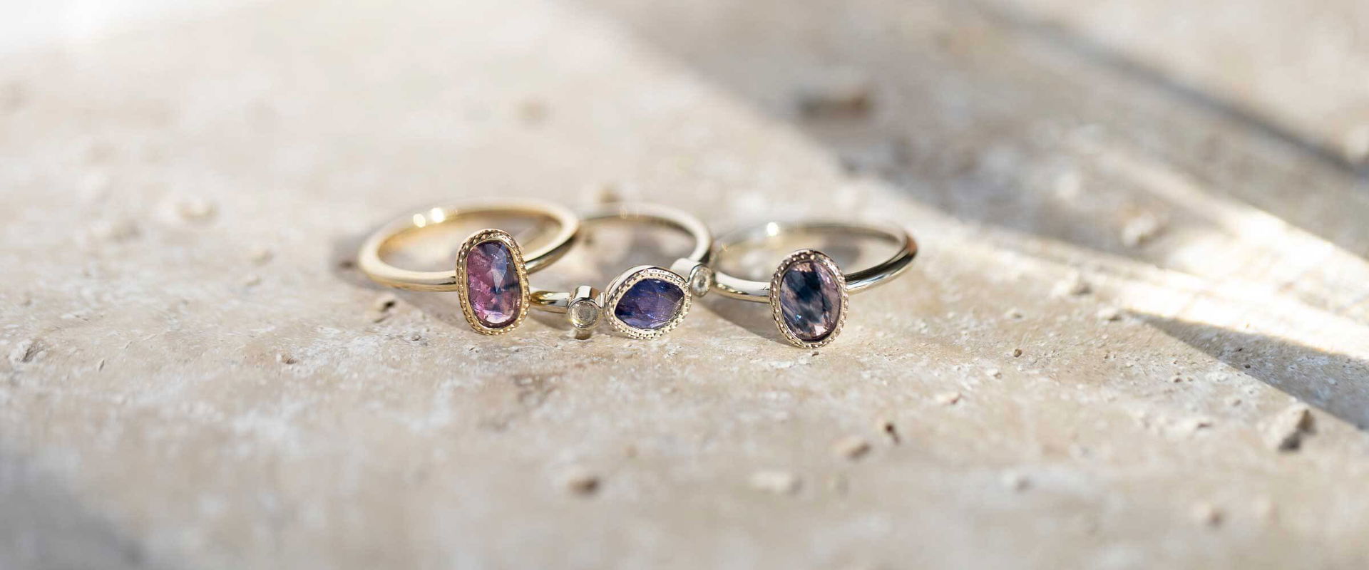 Handcrafted 14k gold stacking rings with rose-cut pink & violet sapphires by Sara Gallo, Lancaster PA.	