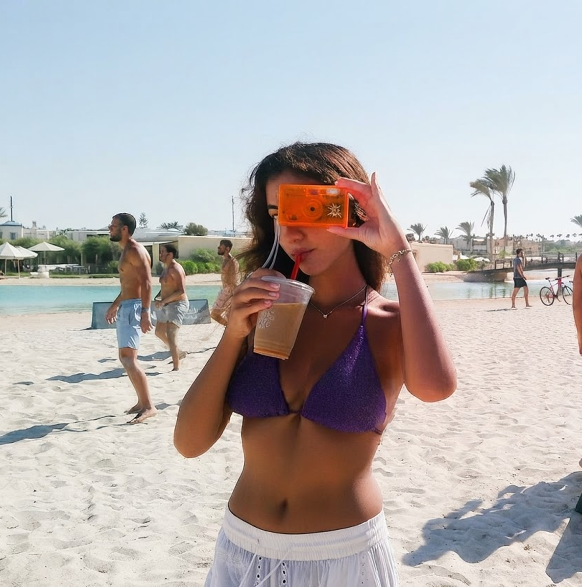 Woman on the beach shooting with an orange Candid Mini