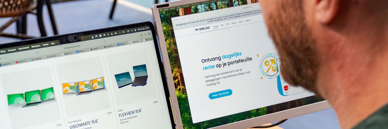 Person looking at a laptop screen and a portable monitor displaying product listings