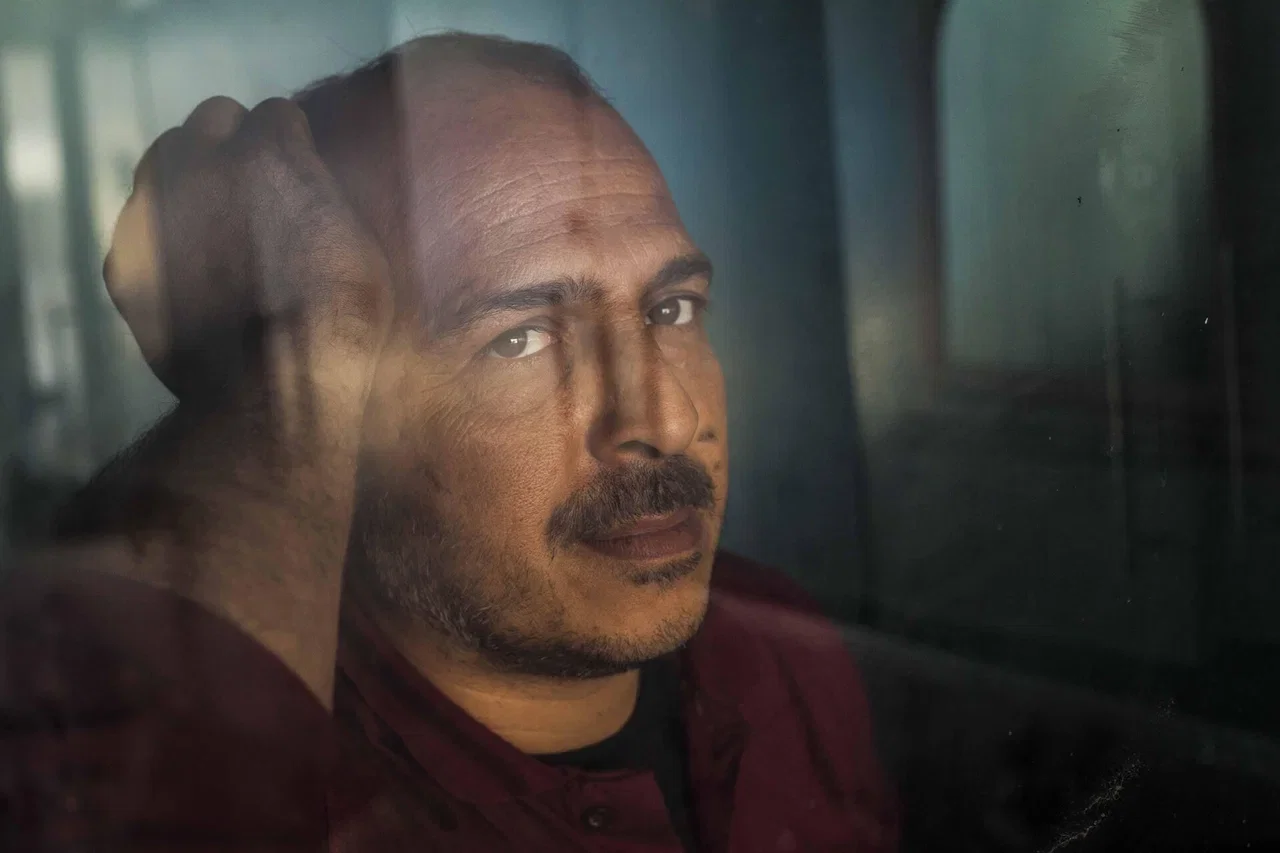 Person sitting by a window in a quiet reflective moment