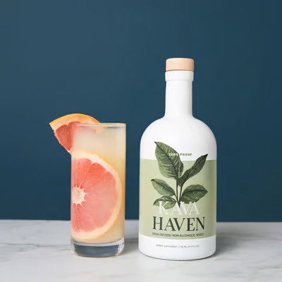 A grapefruit cocktail made with Kava Haven next to the bottle