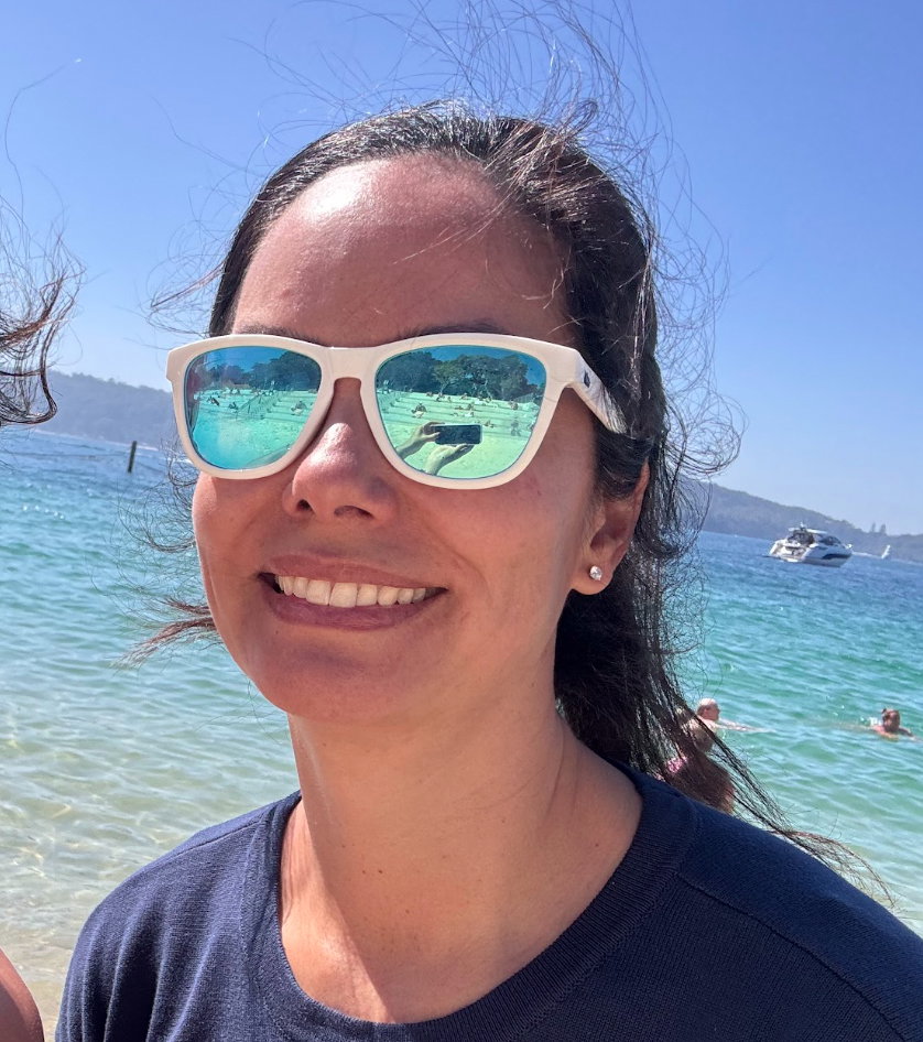 Smiling woman on a paddleboard wearing Signature floating sunglasses